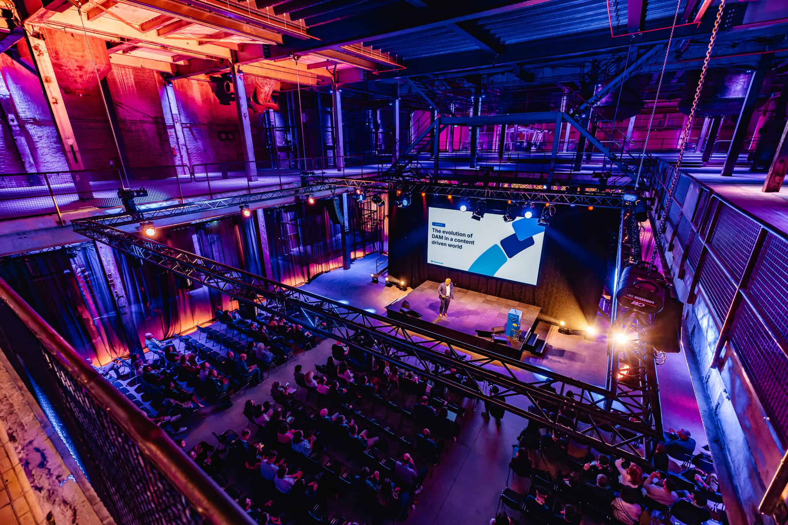 Industriegebouw Middenfabriek met evenement en publiek, kleurrijke verlichting en grote schermen voo.