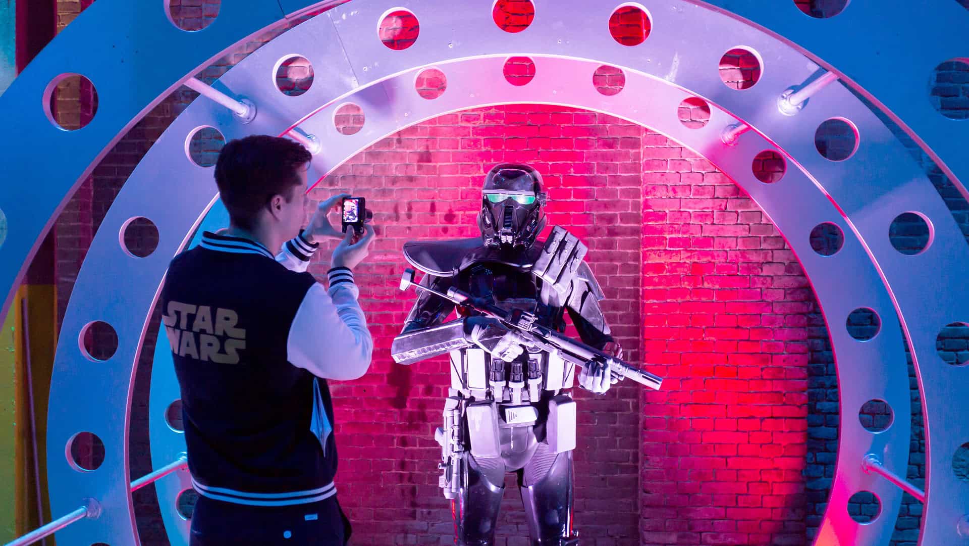 Person in Star Wars Mandalorian costume taking a photo at SugarFactory.